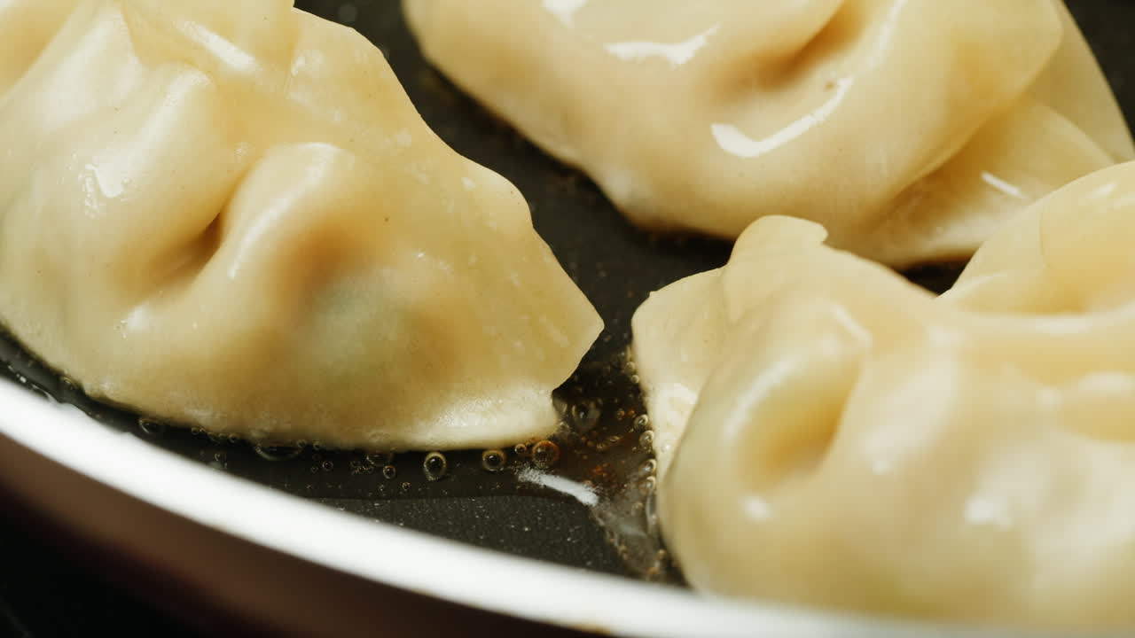 Close-Up of Gyoza Dumplings Frying in a Hot Pan