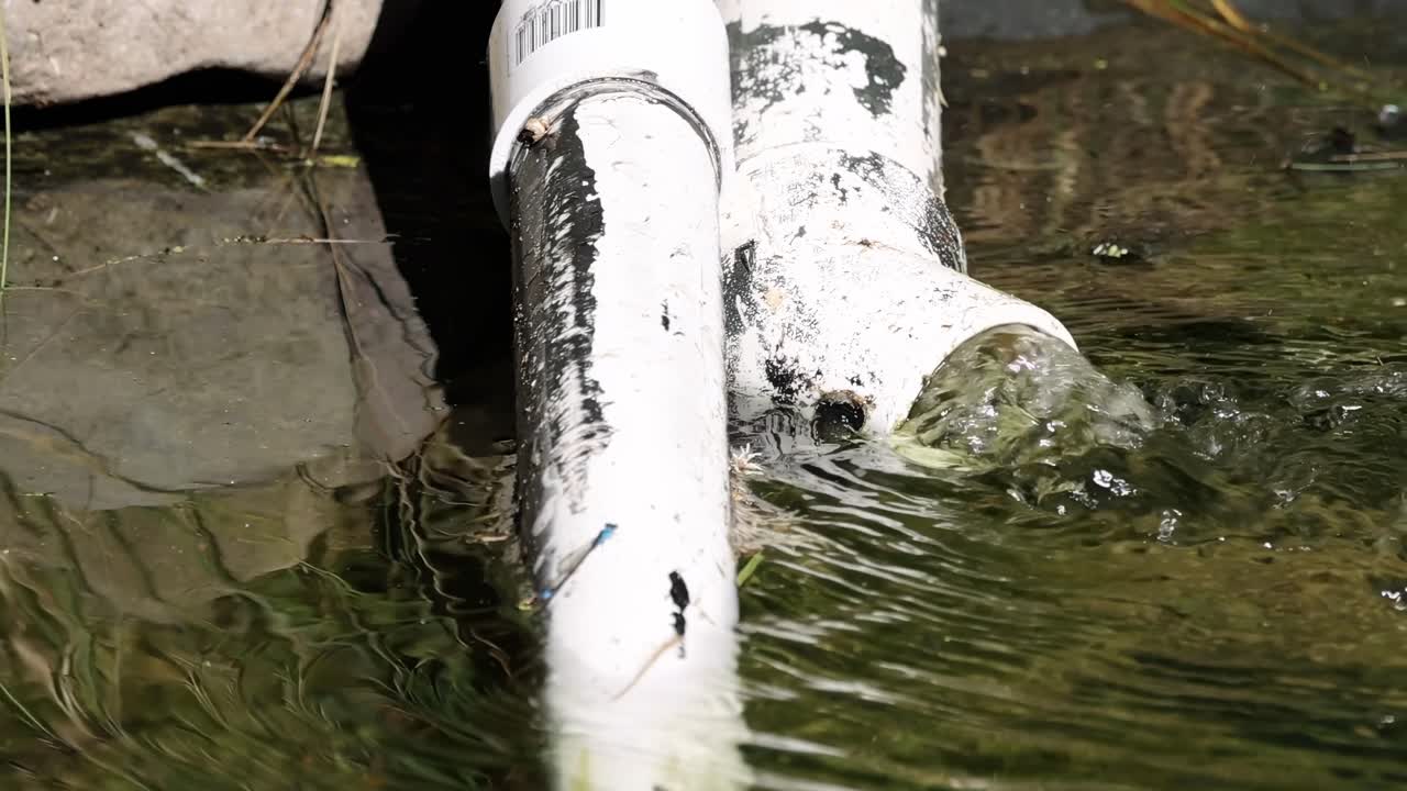 Water Flowing Through PVC Pipes in a Stream