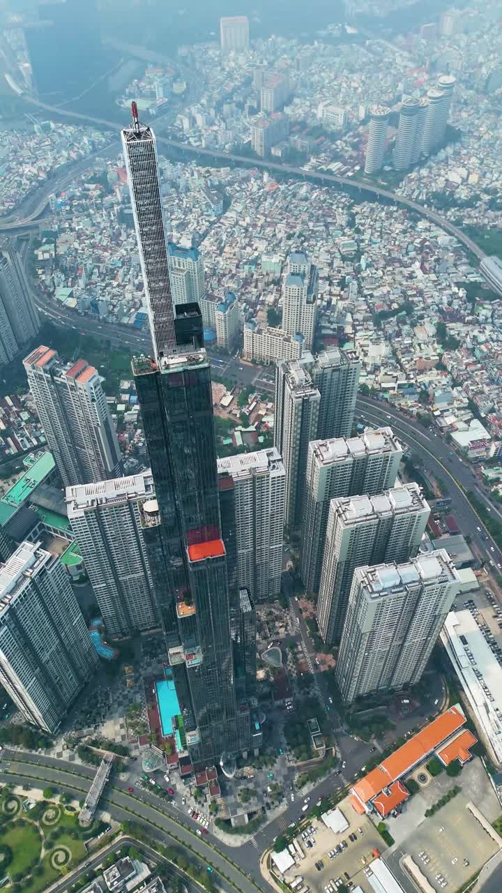 Vertical drone shot above the Landmark 81 supertall skyscraper during the day in Ho Chi Minh City, Vietnam