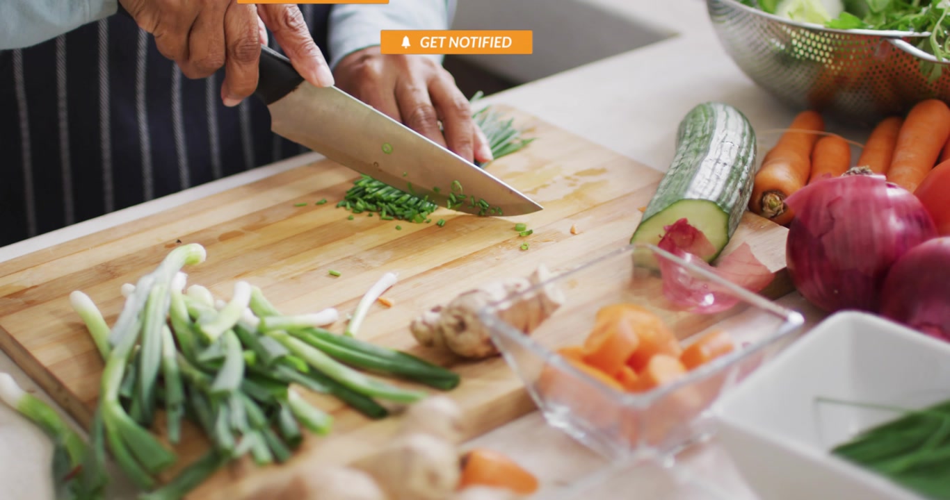 Close Up of Person Chopping Chives on a Cutting Board