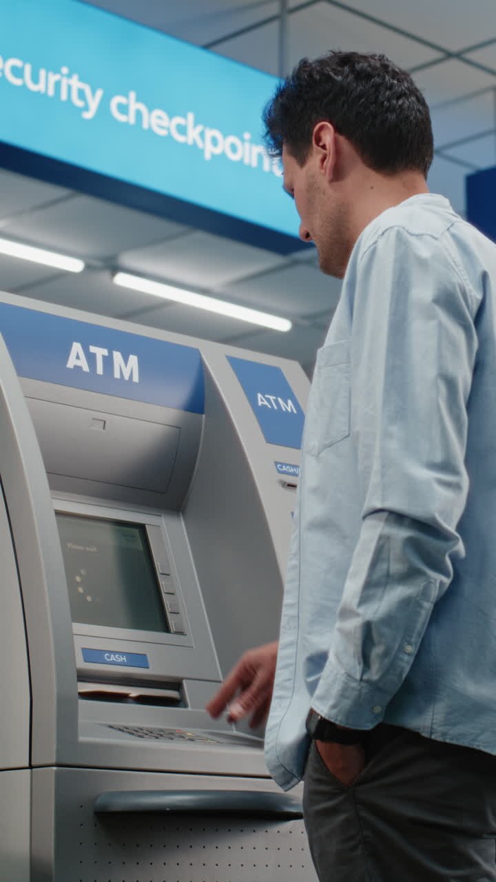 Man using an ATM at a Security Checkpoint