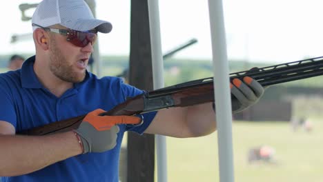 sportsman shoots from a double-barreled shotgun, a sports field for a shooting test is shooting at flying skeet