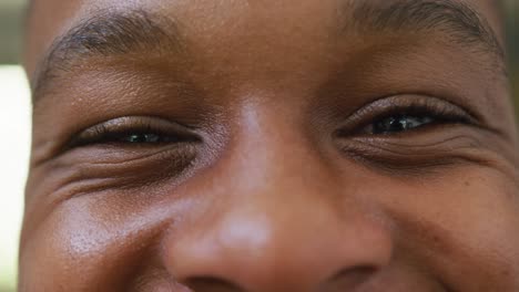 Portrait-of-happy-african-american-male-teenage-boy-at-home,-slow-motion