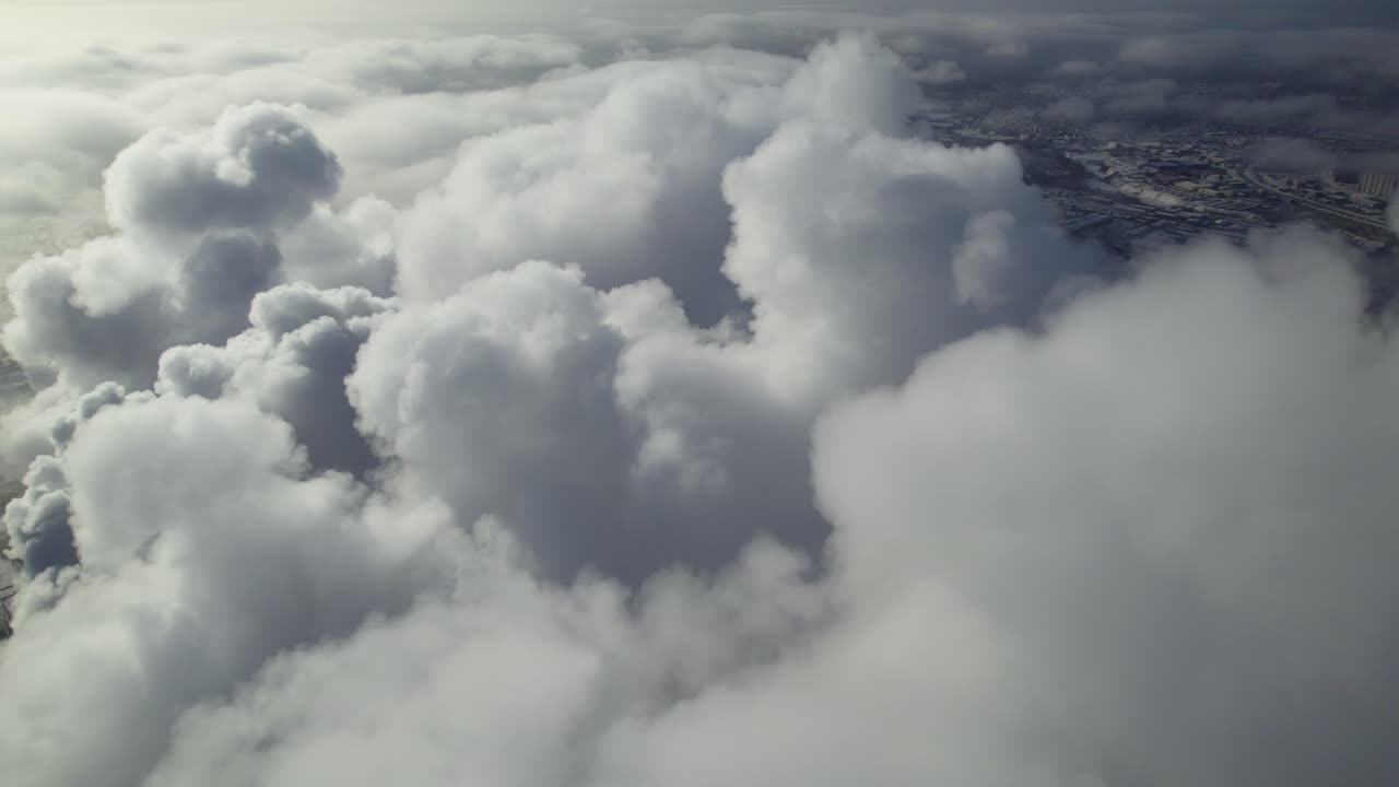Aerial View of Clouds over a Cityscape