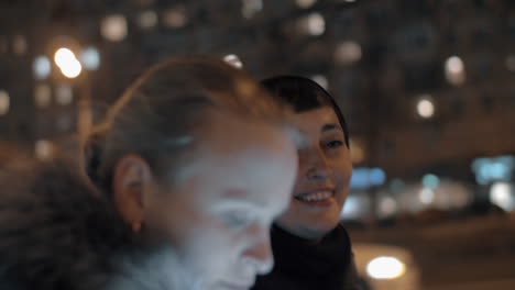 woman sharing news with her friend during evening walk