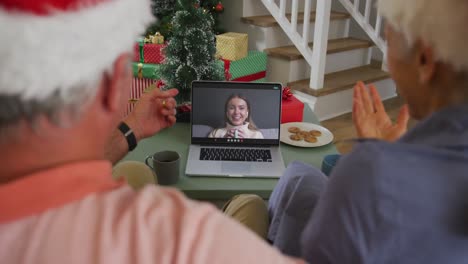 Happy-african-american-senior-couple-on-video-call-with-granddaughter-at-christmas