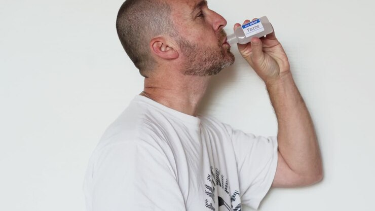 Bearded man drinks fake vaccine for coronavirus from a bottle