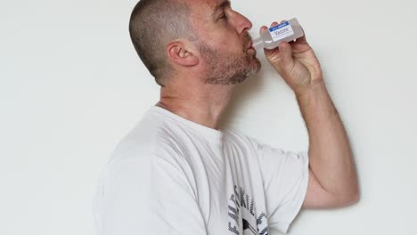 bearded man drinks fake vaccine for coronavirus from a bottle