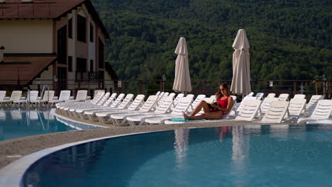 woman reading by the pool at a resort