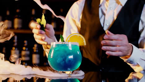 bartender making a blue cocktail with smoke