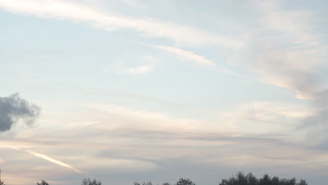 pan from cloudy sky to smoking factory chimney - wide