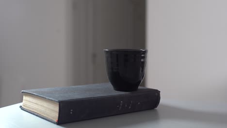 vintage old books on wooden deck tabletop against wall