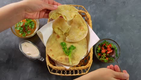 homemade corn flatbread female hand cilantro greens tomato salsa. handmade mexican tortillas vegetable salad traditional indian punjabi makki ki roti bread plate 4k wheat flour dough authentic cuisine