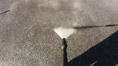 driveway cleaning with high-pressure water jet, slow motion, nobody