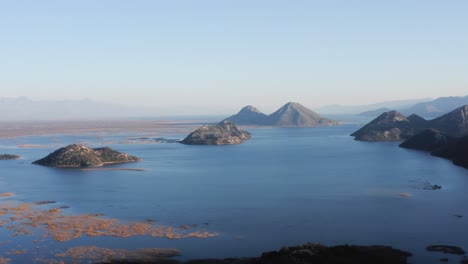 aerial - lake skadar and mountains on a beautiful morning, montenegro, forward