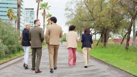 group of business people walking in a park
