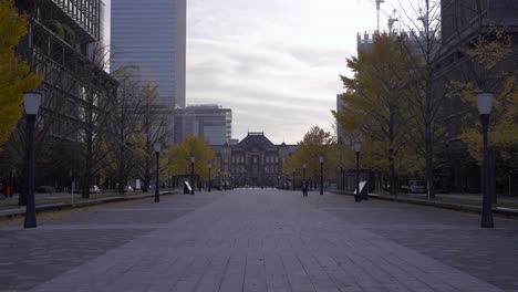 long shot of tokyo station building during early morning hour with few people