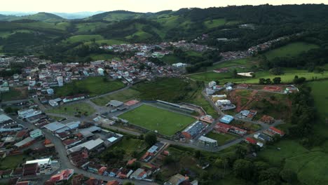 a football pitch surrounded by mountains in a small town in the countryside of minas gerais - bueno brandao, brazil