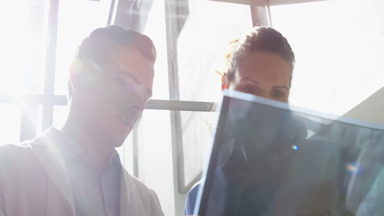 Doctors examining x-ray report
