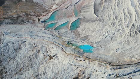 aerial 4k drone video of a tourist attraction pamukkale, natural pool with blue water, turkey calcareous minerals