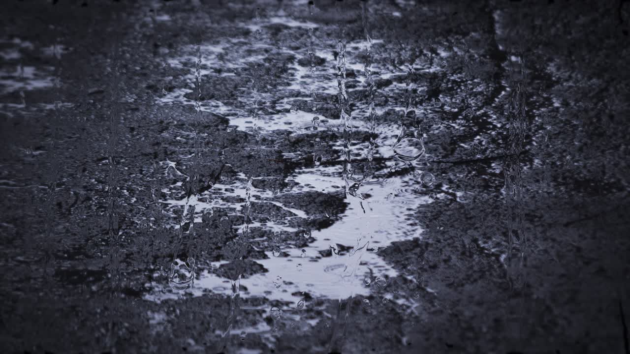 Heavy rain shower downpour cloudburst rainfall behind the glass.