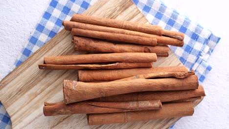 cinnamon sticks on wooden cutting board