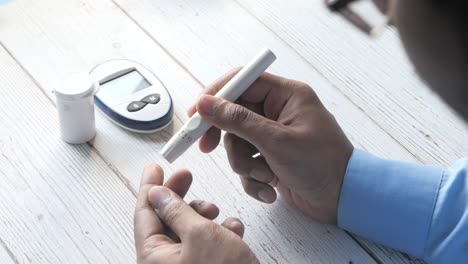 person performing blood sugar test