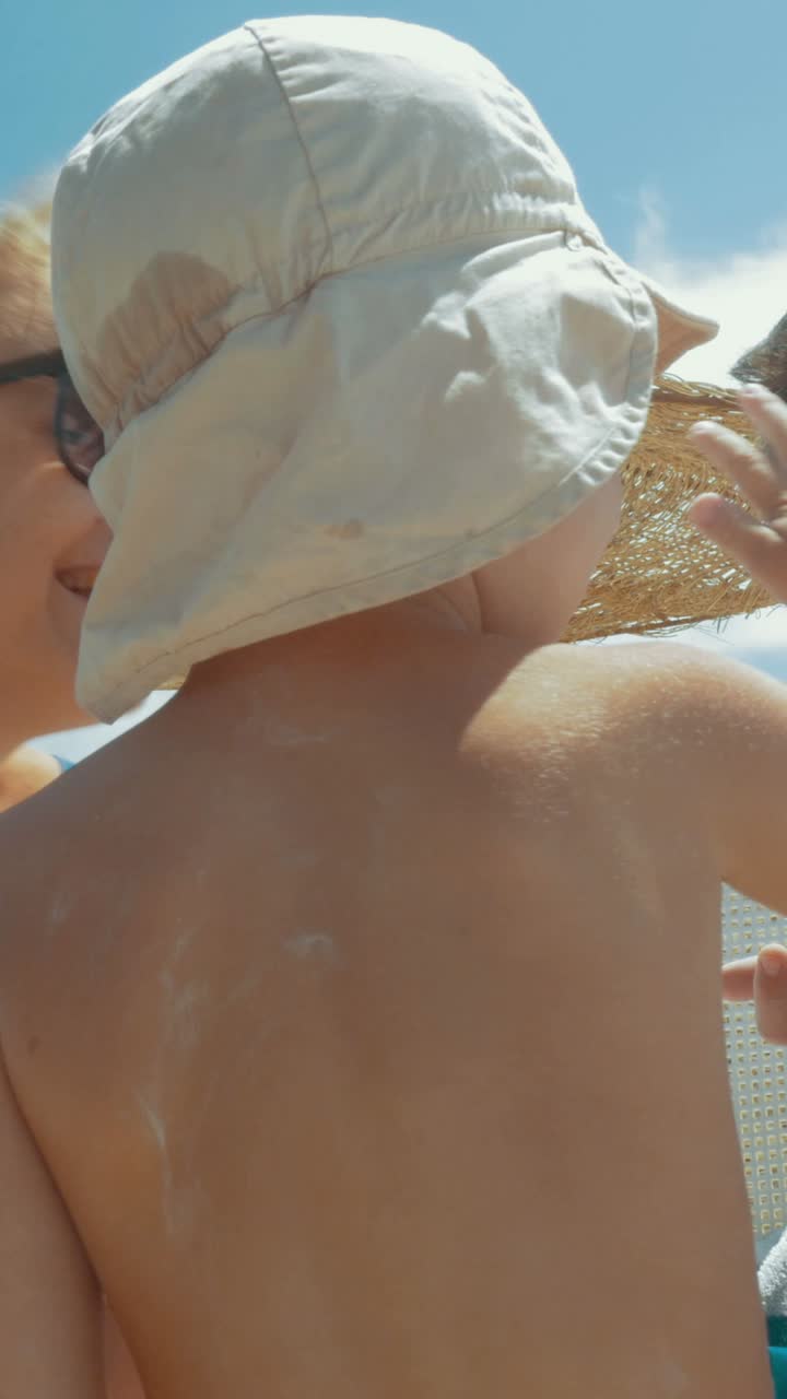 Applying Sunscreen to a Child at the Beach