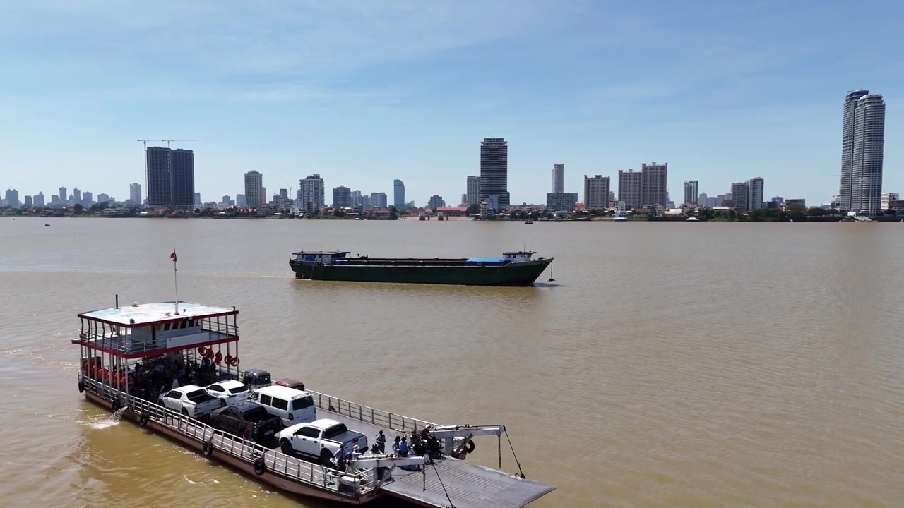 Drone footage above the Mekong river under a beautiful blue sky. Camera is moving foward above the river in the direction of Phnom Penh, Cambodia 1 - 3