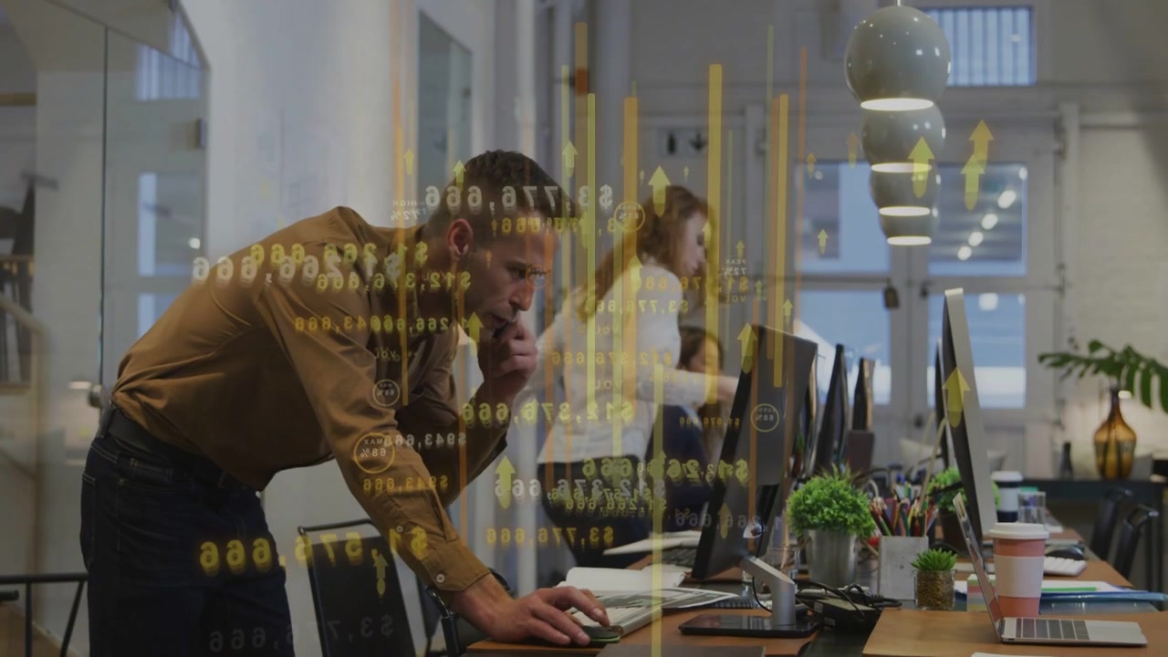 Diverse coworkers working at desk wearing business shirts with monitors, handset and gold overlay
