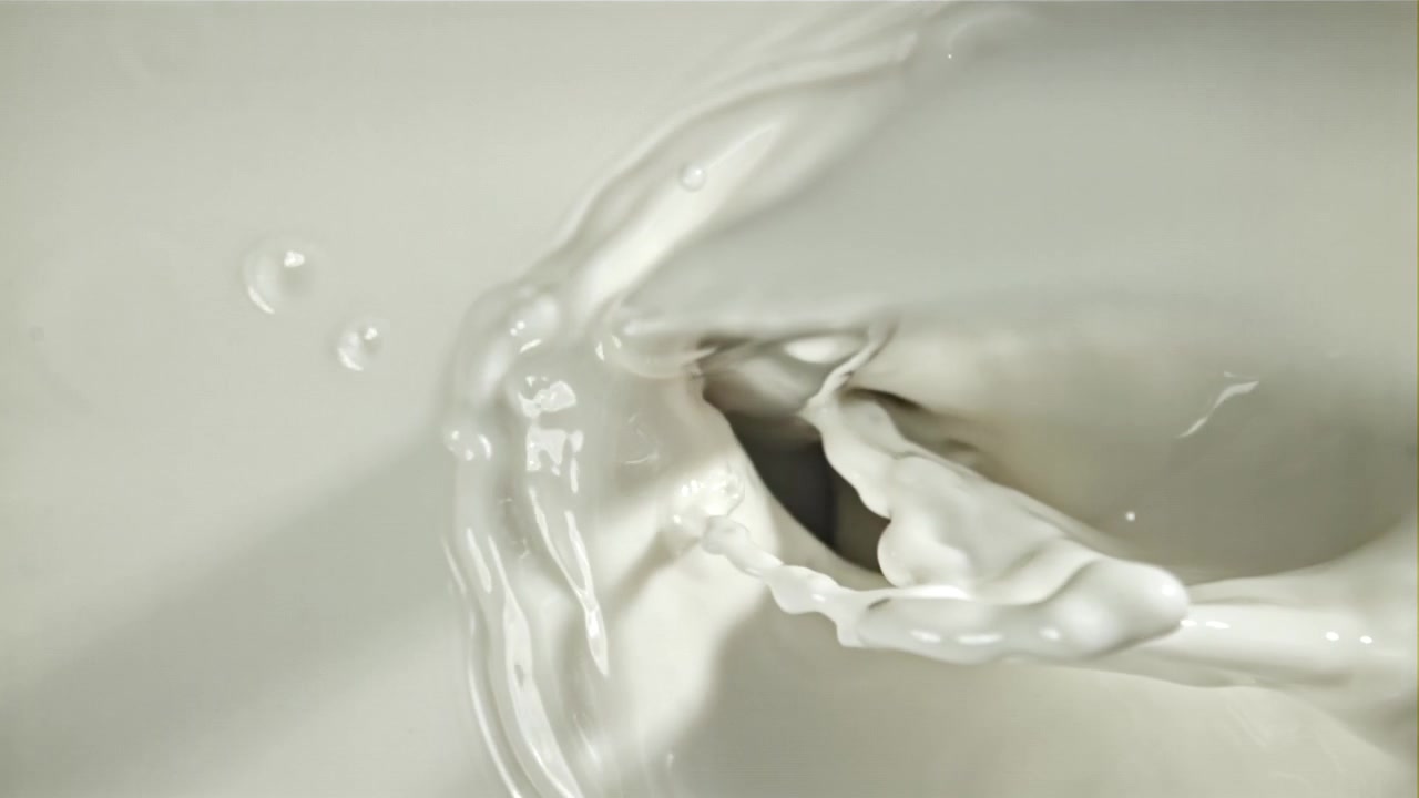 Slow Motion Milk Splash and Pour with Bubbles