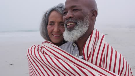 Mature-couple-enjoying-time-outside-by-the-sea