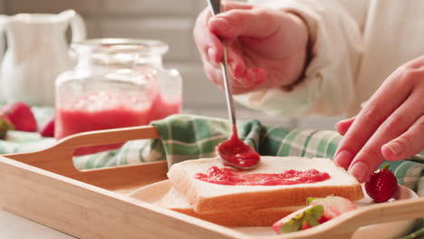 making strawberry jam toast