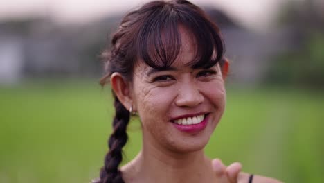 happy woman making finger heart gesture outdoors