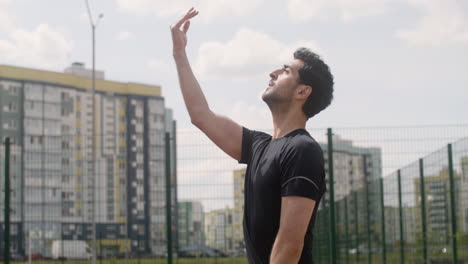 side view of brunet man hitting a volleyball