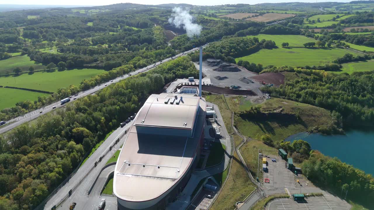 Renewable energy incinerator and motorway captured by drone near Loughborough, United Kingdom, summer landscape
