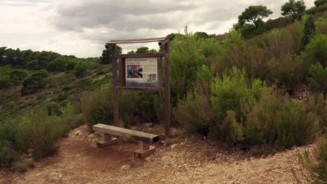 wooden chair in front of hiking sign trail for taking picture spot