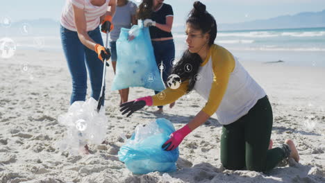 animation of globe icons over diverse female volunteers picking up rubbish on beach