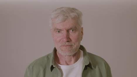 portrait of a senior man smiling at camera