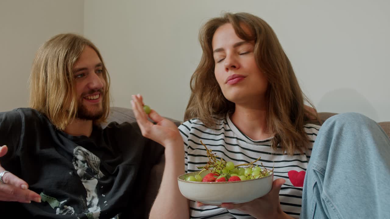 Couple Enjoying Fruit Snack on the Sofa