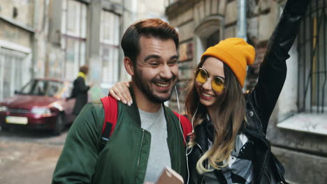 close-up view of young caucasian couple of friends walking down the street