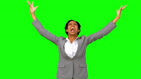 Angry-businesswoman-raising-arms-on-green-screen