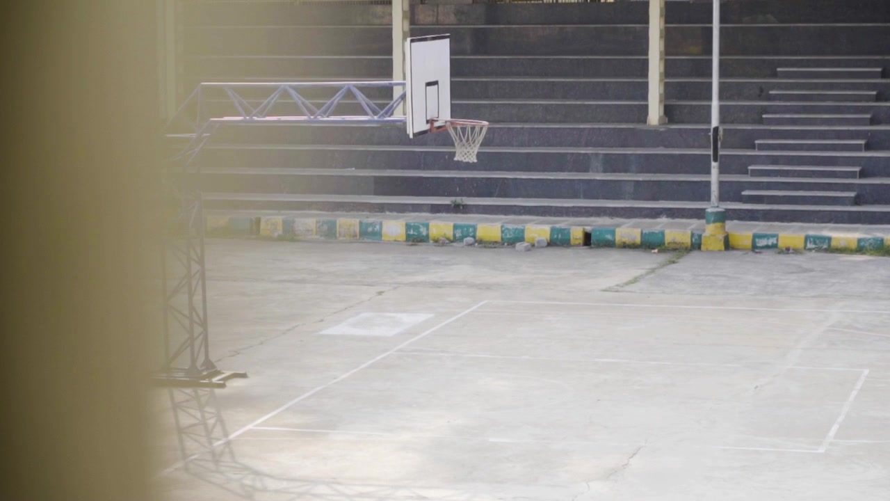 Slow motion reveal of an empty basketball court