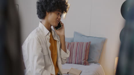 teenager talking on phone in bedroom