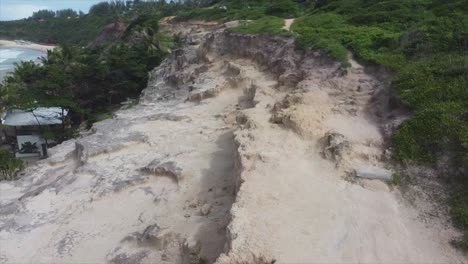 jagged cliffside follow pan to over view of beach in brasil