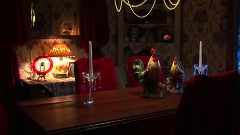 candles sit on a formal dining table under a chandelier