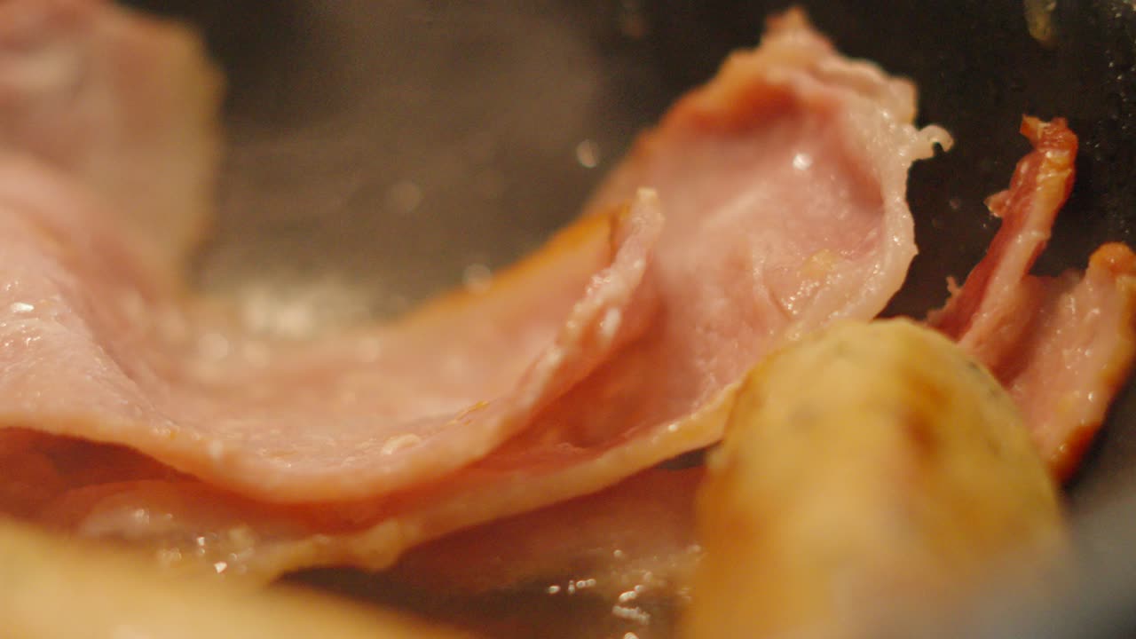 Close Up Details of Bacon Slices in Hot Pan with Steam Rising in Slow Motion. Cooking Breakfast Morning Food Footage.