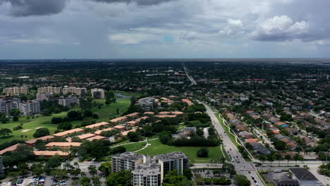 a high angle, aerial view over a suburban neighborhood in florida during a cloudy day