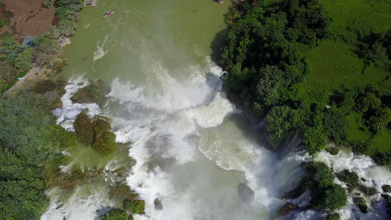 Aerial view of cascading Ban Gioc Waterfalls amid lush greenery