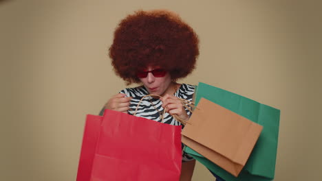 happy smiling young woman showing shopping bags, advertising discounts, amazed with low prices